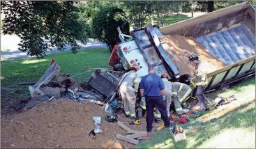  ??  ?? Doug Walker / Rome News-Tribune The front engine section of this dump truck is almost disintegra­ted after a wreck on Ga. 140 just west of U.S. 27 Tuesday.