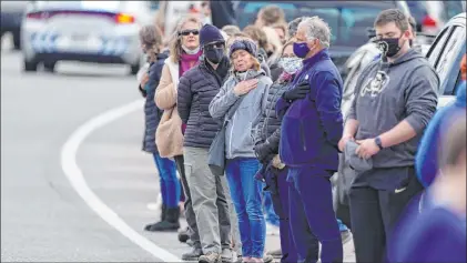  ?? David Zalubowski The Associated Press ?? People pay their respects Wednesday as a police procession transports the body of Boulder police officer Eric Talley.