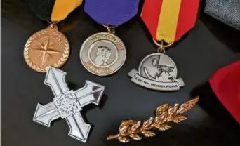  ?? ROBERT MOTUM ?? Medals the author received from micronatio­ns that granted him citizenshi­p.