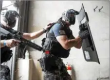  ?? RICK KAUFFMAN — DIGITAL FIRST MEDIA ?? A tactical ballistic shield is designed to deflect bullets fired at the carrier, which makes sense that the shield carrier would be the first through the door in SWAT operations.