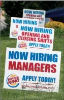  ?? The Associated Press ?? A row of signs advertisin­g jobs are posted in front of a Burger King restaurant in Harmony, Pa.