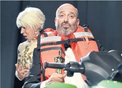  ?? GETTY IMAGES ?? Helen Mirren and Mark Bridges sit on the Jet Ski that Bridges won for having the shortest Oscar acceptance speech.