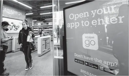  ?? Elaine Thompson / Associated Press ?? A shopper leaves an Amazon Go store in Seattle after checking out from the store without a cashier. A year after Amazon opened its first cashierles­s store, startups and retailers are racing to get similar technology in other stores throughout the world.