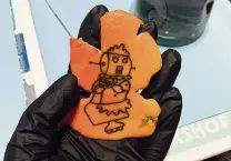  ?? Courtesy Annika Case ?? Rosie the Robot from “The Jetsons,” an orange peel tattoo by San Antonio tattooist Annika Case. Case has been practicing her stick-and-poke method on orange peels since the lockdown.