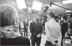  ?? LOIC VENANCE/GETTY-AFP ?? French President Emmanuel Macron meets employees Tuesday at the family allowance public service in Tours, in central France.