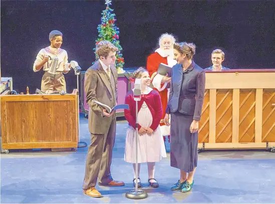  ?? DESALES UNIVERSITY ?? Little Susan Walker (Charlotte Myers, center) doesn’t believe in Santa Claus until she meets the real Kris Kringle (Wayne Turney, in Santa suit) in Act 1 DeSales University’s production of “Miracle on 34th Street: A Live Musical Radio Play.”