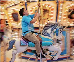  ??  ?? Homar Ramos, 9, enjoys the ride on the carousel.