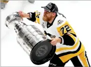  ?? JEFF ROBERSON ?? Pittsburgh Penguins’ Patric Hornqvist (72), of Sweden, hoists the Stanley Cup after defeating Nashville Predators in Game 6 of the NHL hockey Stanley Cup Final, Sunday, in Nashville, Tenn.