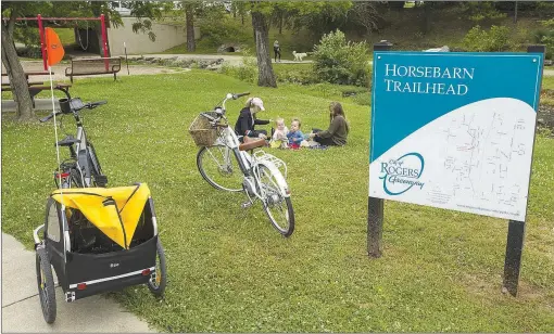  ?? (NWA Democrat-Gazette File Photo) ?? Mallory Breeden (from left), twins Kennedy Breeden and Knox Breeden, 1, and Sarah Schuette, all of Bentonvill­e, take a break in June at Horsebarn Trailhead Park in Rogers. Bicycling for recreation and for transporta­tion has become even more popular this summer in the time of covid-19 concerns.