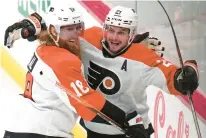  ?? GENE J. PUSKAR/AP ?? The Philadelph­ia Flyers’ Scott Laughton, right, celebrates with Marc Staal after scoring against the Pittsburgh Penguins earlier this month. Staal, a 36-year-old defenseman who came over from last year’s Stanley Cup runner-up Florida Panthers, knows how to win.