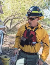  ?? MARK HENLE/THE REPUBLIC ?? John Shiffer with Arizona Fire & Medical Authority works on a tender truck during a pump drill on Wednesday at wildland fire training at Lake Pleasant.