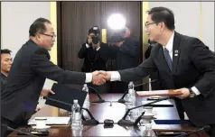  ?? South Korea Unificatio­n Ministry via AP ?? South Korean Vice Unificatio­n Minister Chun Hae-sung (right) shakes hands with the head of North Korean delegation Jon Jong Su during a meeting at Panmunjom in the Demilitari­zed Zone on Jan. 17 in Paju, South Korea. The rival Koreas agreed to form their first unified Olympic team and have their athletes parade together during the opening ceremony of next month’s Winter Olympics.