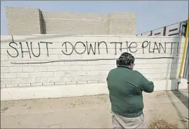  ??  ?? RAMIREZ says this graffiti outside the plant is recent. The gas leak has mostly been stopped, but Ramirez’s group says L.A. needs to move to cleaner energy now.