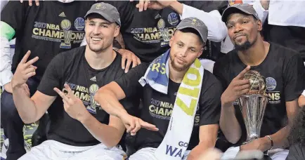  ?? MARCIO JOSE SANCHEZ/AP ?? From left, Klay Thompson, Stephen Curry and Finals MVP Kevin Durant celebrate their NBA championsh­ip in 2017.