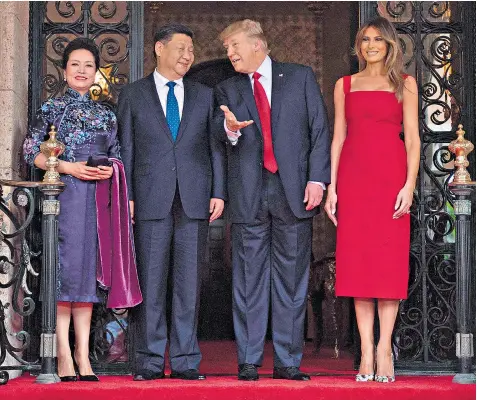  ??  ?? President Xi Jinping and his wife Peng are welcomed by President Donald Trump and first lady Melania after their arrival at the Mar-a-Lago estate in West Palm Beach, Florida