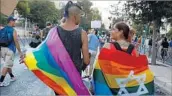  ?? Gali Tibbon AFP/Getty Images ?? MARCHERS paraded amid a heavy police presence. In 2015, a teenage marcher was stabbed to death.