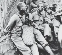  ?? U.S. MARINE CORPS VIA THE ASSOCIATED PRESS ?? BELOW: American prisoners of war pause for a moment with their arms tied behind their backs. This photograph was stolen from the Japanese during the three years of occupation of the Philippine­s during World War II.