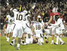  ?? Marcio Jose Sanchez / Associated Press 2009 ?? Cal players celebrate the intercepti­on by Mike Mohamed (18) that clinched a 34-28 win for the Bears in the 2009 Big Game.