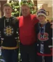  ??  ?? Craig Horsley with his sons Ross, left, and Max in Boston preparing to attend the recent game — a Christmas present for the two boys.