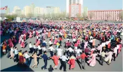  ??  ?? PYONGYANG: People dance to celebrate the fifth anniversar­y of respected Supreme Leader Kim Jong Un’s assumption of the top posts of the Workers’ Party of Korea and the state. — AFP