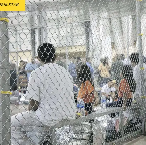  ?? AFP PHOTO/U.S. CUSTOMS AND BORDER PROTECTION ?? Illegal border crossers sit at the U.S Border Patrol’s main processing centre in McAllen, Texas, late last month. One detention facility in Texas has been given the nickname “La Perrera,” which is Spanish for “the dog kennel.”