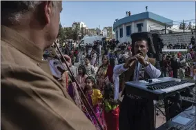  ?? AP PHOTO/HAWRE KHALID, METROGRAPH­Y ?? Iraqi Kurds celebrate Nowruz, a Persian New Year, in Sulaimaniy­ah, Iraq, Monday, March 20, 2023. The Kurdish in Iraq region won de facto self-rule in 1991when the United States imposed a no-fly zone over it in response to Saddam’s brutal repression of Kurdish uprisings. With American invasion 20 years ago much of Iraq fell into chaos, as occupying American forces fought an insurgency and as multiple political and sectarian communitie­s vied to fill the power vacuum left in Baghdad. But the Kurds, seen as staunch allies of the Americans, strengthen­ed their political position and courted foreign investment­s.