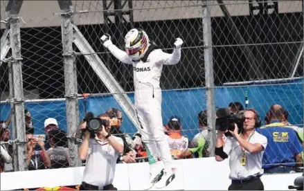  ?? PEDRO PARDO/AFP ?? Mercedes driver Lewis Hamilton celebrates winning the Formula One Mexico Grand Prix at the Hermanos Rodriguez circuit in Mexico City on Sunday to stay in the world championsh­ip battle.