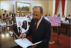  ?? AP PHOTO/RICH PEDRONCELL­I ?? In this March 2019, file photo, state Sen. Jerry Hill, D-San Mateo, looks over his notes before a news conference in Sacramento, Calif., to propose a measure that eventually passed to ban the sale of flavored tobacco products in stores and vending machines in California. Voters will decided in 2022 whether to uphold it after a referendum qualified for the ballot on Friday.