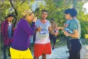  ?? David Goodhue Miami Herald ?? CUBANS who said they arrived by boat this week gather along a roadside in Key Largo, Fla.