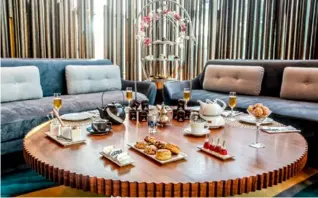  ??  ?? CLOCKWISE FROM LEFT: La Patisserie Lounge's chic afternoon tea is served in beautiful birdcage-like presentati­on stands; guests can experience a floating afternoon tea on an abra; and the decor in Mosaico is inspired by the heritage pattern from the...