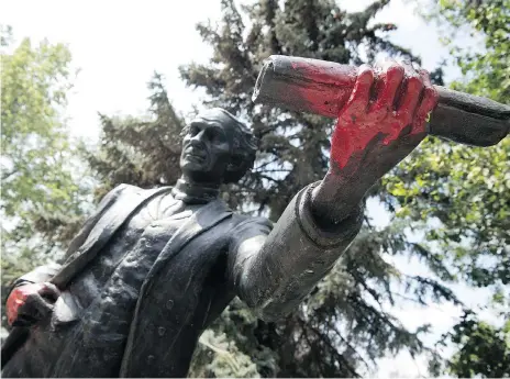  ?? TROY FLEECE ?? Overnight Monday, someone sprayed red paint on the hands of the Sir John A. Macdonald statue in Victoria Park in Regina.