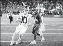  ?? Young Kwak Associated Press ?? DUCKS quarterbac­k Justin Herbert, shown scoring against Washington State, was placed in the concussion protocol.