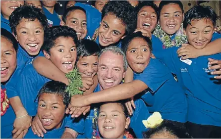  ??  ?? Local hero: I Have A Dream New Zealand founder Scott Gilmour with some of the youngsters involved in the Mt Roskillbas­ed programme. Mr Gilmour is a semifinali­st in the 2013 Kiwibank New Zealander of the Year Local Hero Awards.