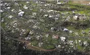  ?? GERALD HERBERT — ASSOCIATED PRESS FILE ?? Homes and other buildings destroyed by Hurricane Maria lie in ruins on Sept. 28 in Toa Alta, Puerto Rico. Puerto Rico’s governor ordered a recount Monday of related deaths.