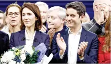  ?? — AFP photo ?? France’s Prime Minister Gabriel Attal (centre right) applauds as he stands on stage next to French Member of the European Parliament and head of list for the Renew (Renaissanc­e) group Valerie Hayer (centre left) at the end of the launch of the Renew Europe Party’s political campaign for the upcoming European Parliament elections, in Lille, northern France.