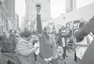  ?? Jose F. Moreno / Associated Press ?? Jennifer Bennetch and her son, Yusuf Williams-Bey, protest Monday outside the Starbucks on 18th and Spruce streets in Philadelph­ia, where two black men were arrested last week.