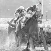  ?? Peter Morgan Associated Press ?? JOCKEY JOSE ORTIZ brings Tapwrit to the finish line in the Belmont Stakes, ahead of Irish War Cry.