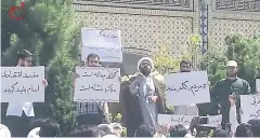  ?? AFP ?? BELOW In this video grab, a cleric speaks to a crowd of protesters demonstrat­ing in Mashhad. Iranian authoritie­s have barely mentioned days of protests in its major cities as sanctions loom.