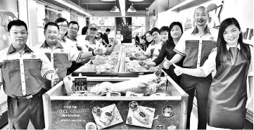  ??  ?? Rena (right), Frederick (second right) and others give their thumbs-up to the Pure South lamb and mutton at a CCK outlet.