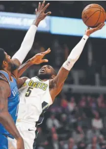  ?? John Leyba, The Denver Post ?? Nuggets guard Will Barton goes up for a shot over Oklahoma City Thunder forward Paul George in the second quarter of Denver’s 96-86 loss Tuesday night.