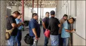  ?? ETHEREDGE / THE NEW YORK TIMES 2017 GEORGE ?? Truck drivers in Nuevo Laredo, Mexico, line up at a dispatch window at Fema, one of Mexico’s largest trucking companies, to see what cargo they would be hauling to the U.S. Mexican drivers must hand off their cargo at certain border zones in the U.S.;...