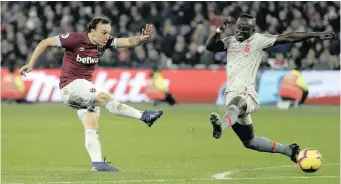  ??  ?? WEST Ham’s Mark Noble, left, and Liverpool’s Sadio Mane battle for the ball during their Premier League match at the London Stadium on Monday night. The match ended in a 1-1 stalemate. |