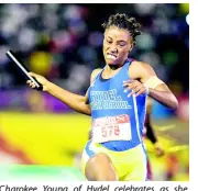  ??  ?? Charokee Young of Hydel celebrates as she crosses the line, after successful­ly anchoring the 4x400m relay team to victory in the 4x400m open final at the ISSA/GraceKenne­dy Boys and Girls’ Athletics Championsh­ips at the National Stadium on Saturday, March 30, 2019.