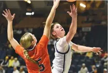  ?? STAFF PHOTO BY MATT HAMILTON ?? UTC freshman guard Brooklyn Crouch, right, shoots as Mercer’s Erin Houpt defends during Saturday’s SoCon game at McKenzie Arena. UTC won 78-70 in overtime, improving to 10-8 overall and 2-1 in the SoCon.