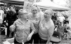  ??  ?? (From right) Gan shares a light moment with Chan and Ho after having their heads shaved at the GNF Church in Green Heights.