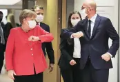  ?? PHOTO: REUTERS ?? Germany’s Chancellor Angela Merkel and European Council President Charles Michel are seen bumping elbows ahead of the first face-to-face EU summit since the Covid-19 outbreak, in Brussels, on Friday. Finnish PM Sanna Marin and French President Emmanuel Macron are also seen