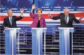  ?? JOHN LOCHER/AP ?? Democratic presidenti­al candidates Mike Bloomberg, Elizabeth Warren and Bernie Sanders at the debate in Las Vegas on Wednesday.
