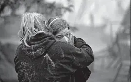  ?? JOHN LOCHER/AP ?? Krystin Harvey, left, comforts her daughter Araya Cipollini near the remains of their home burned in wildfires Saturday in Paradise, Calif.