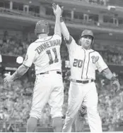  ?? GREG FIUME/GETTY IMAGES ?? Washington’s Ian Desmond celebrates his two-run home run during the eighth inning vs. Miami with Ryan Zimmerman on Monday.