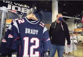  ?? Elise Amendola / Associated Press ?? Football fan Brian Pope browses for Tom Brady jerseys Monday in the pro shop at Gillette Stadium in Foxborough, Mass. Brady is going to the Super Bowl for the 10th time, and Patriots fans are cheering for him — just like before.